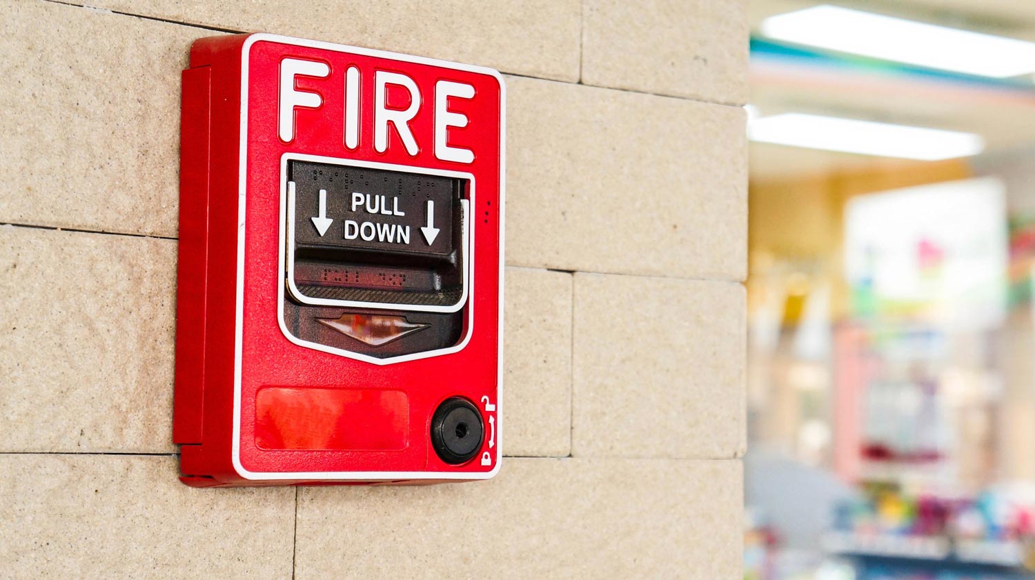 Closeup of a fire alarm in a school.